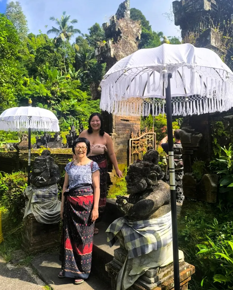 Guests at a lush Balinese temple garden